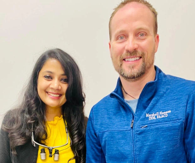 Dr. Radhika Srikrishnan Iyer posing with a male patient at Dental Artistry Irving