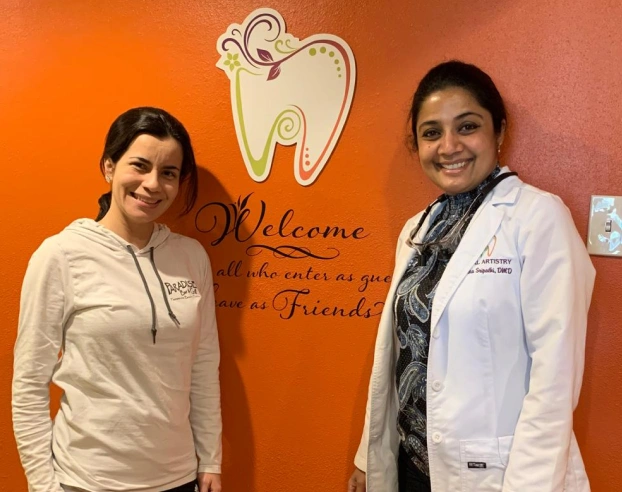 Dr. Radhika Srikrishnan Iyer posing with a smiling patient at Dental Artistry Irving
