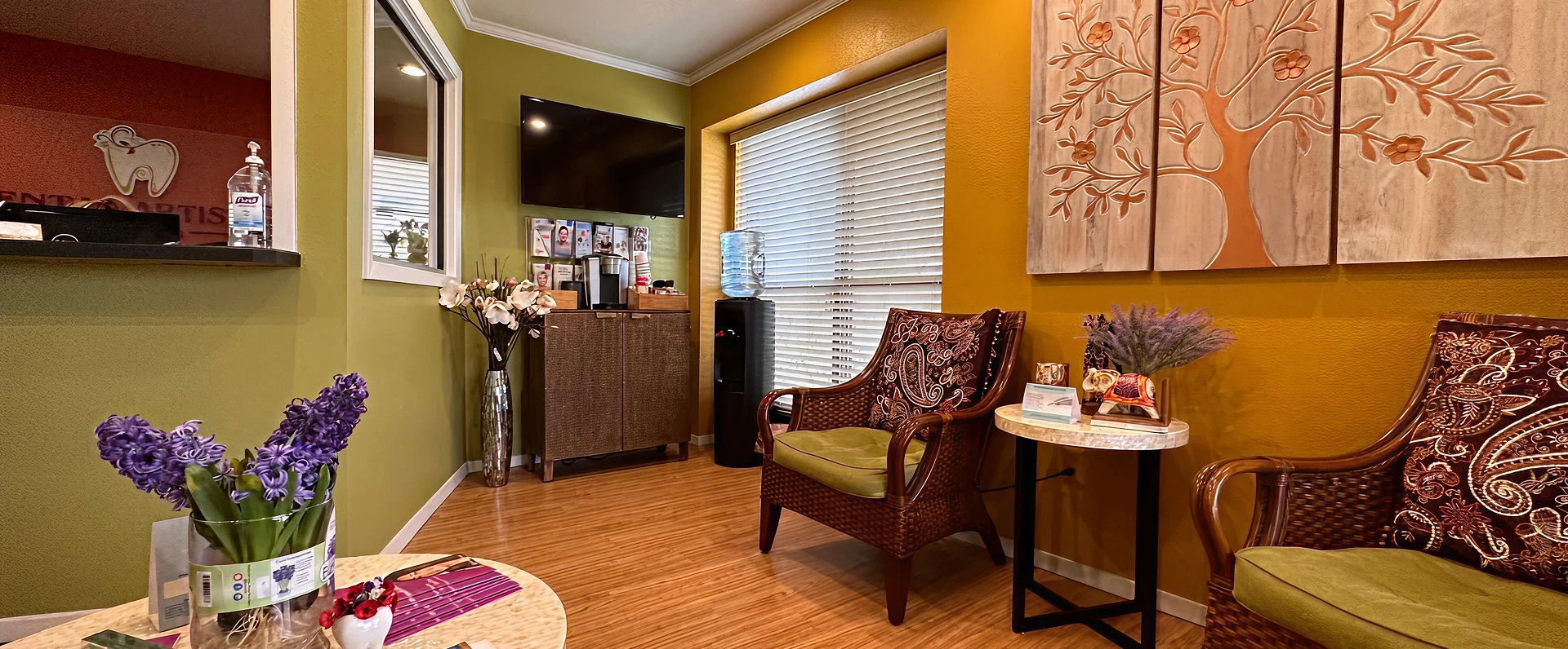 Dental Artistry Irving waiting room with warm toned walls and wooden furniture